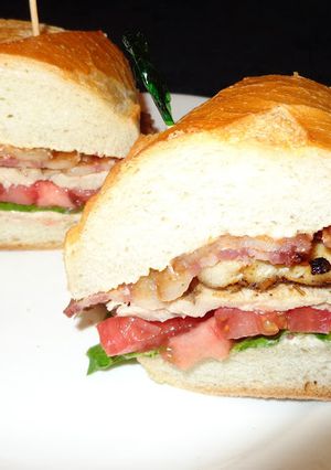 A picture of Grilled Chicken Thigh Sandwich with Smoked Bacon on Italian Bread.