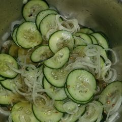 A picture of Cucumbers and onions.