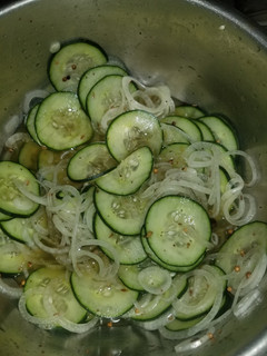 A picture of Cucumbers and onions.