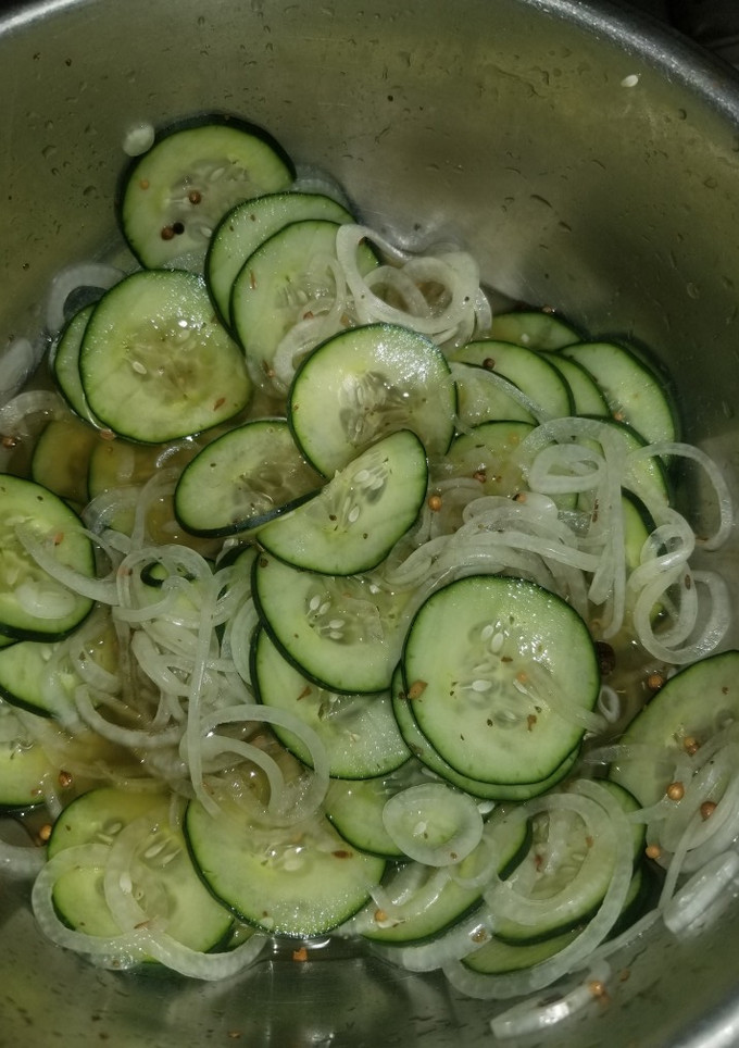 A picture of Cucumbers and onions.