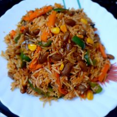 A picture of Mexican Rice with Red Sauce.