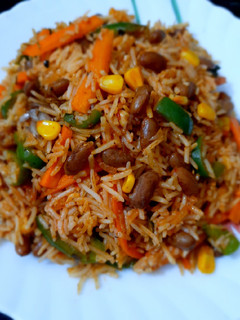 A picture of Mexican Rice with Red Sauce.