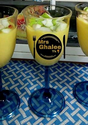 A picture of Mango lassi with green apple.