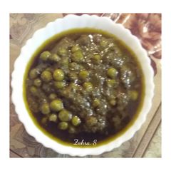 A picture of Aloo matar in green gravy.