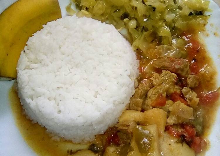 Coconut rice served with beef stew and cabbage