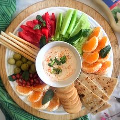 A picture of Smoked paprika garlic sauce with fresh fruits and vegetables.