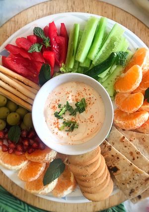A picture of Smoked paprika garlic sauce with fresh fruits and vegetables.