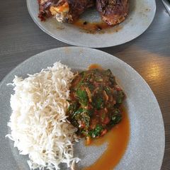 A picture of Tomato Stew infused with green vegetables.