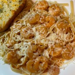 A picture of Shrimp fettuccine with red pepper sauce.