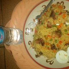 A picture of Indomine with carrots,green peas and boiled eggs.