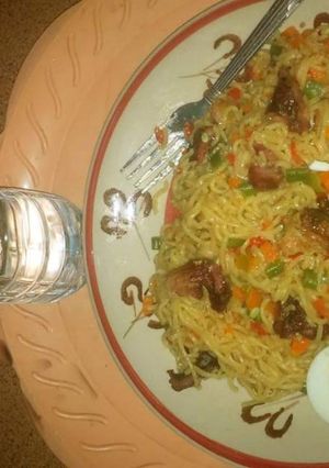 A picture of Indomine with carrots,green peas and boiled eggs.
