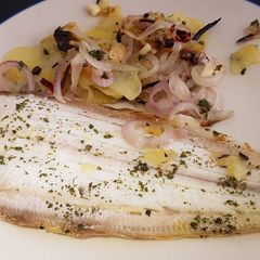 Dover Sole in the oven with hot and crispy onion and potato on the side A picture of Dover Sole in the oven with hot and crispy onion and potato on the side.