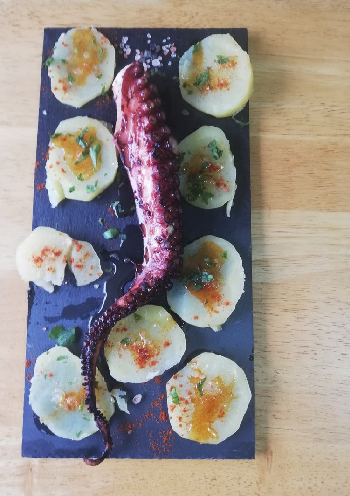 Una foto de Patas de Pulpo a la brasa con patatas cocidas con toque pimentón