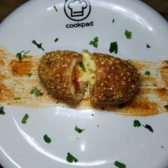 A picture of Cheesy Croquettes in red Sauce.