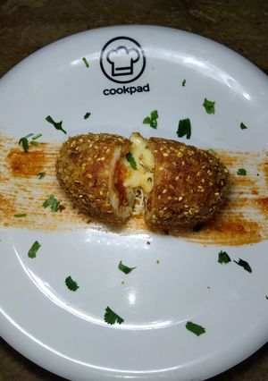 A picture of Cheesy Croquettes in red Sauce.