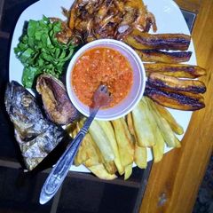 A picture of Fried sweet potatoes,plantain,fish with vegetable and pepper sauce.