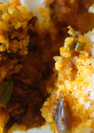 A picture of Steamed ground rice layered with prawn and coconut.
