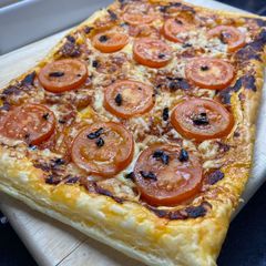 A picture of ‘Nduja pastry with Black Garlic drizzle.