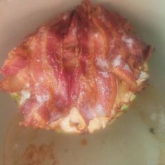 A picture of Bacon-Wrapped, Meatball Stuffed Cabbage w/sauce.