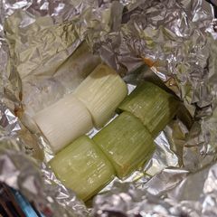 A picture of Leek baked in aluminium foil.