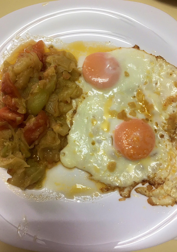 Una foto de Calabacín con cebolla y tomate con huevos a la plancha