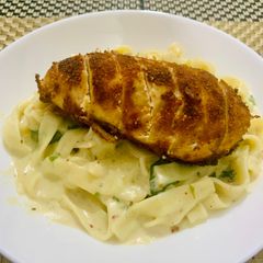 A picture of Crusted Chicken with Alfredo fettuccine.