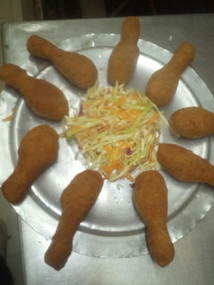 A picture of Bread crumbed drumsticks.