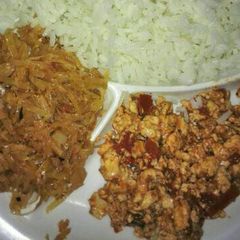 A picture of Scrambled eggs, fried cabbage and plain rice.