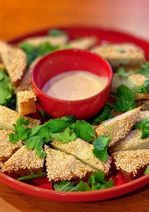 A picture of Prawn Toast with Yuzu Mayo, Coriander and Mint.