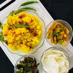 A picture of Khichadi with fried bhindi and Papad.