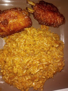 A picture of Rice and beans with chicken.