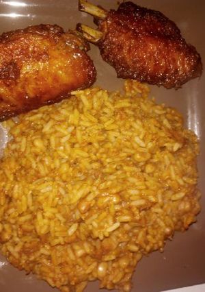 A picture of Rice and beans with chicken.