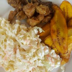 A picture of Fried plantain with coleslaw and fried chicken.