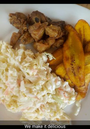 A picture of Fried plantain with coleslaw and fried chicken.