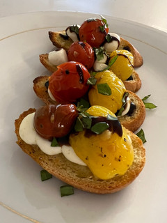 A picture of Bruschetta and Mozzarella on Crostini.