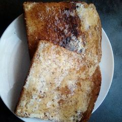 A picture of Toasted bread with butter and jam.