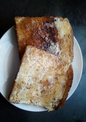 A picture of Toasted bread with butter and jam.