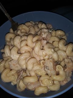 A picture of Bacon Alfredo with shrimp and mushrooms.