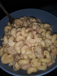 A picture of Bacon Alfredo with shrimp and mushrooms.