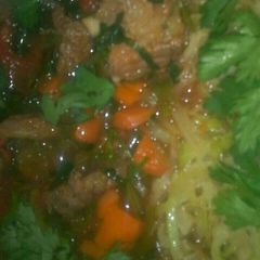 A picture of Beef stew and fried cabbage.