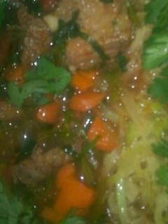 A picture of Beef stew and fried cabbage.