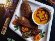 A picture of chicken in a red pepper sauce