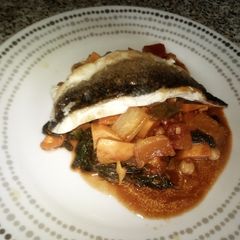 A picture of Pan fried Seabass on a Mediterranean Stew.