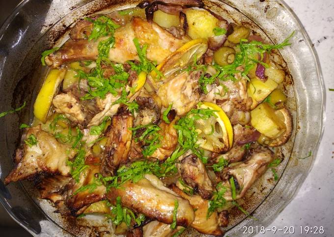 Baked chicken with lemon, potato and green olives