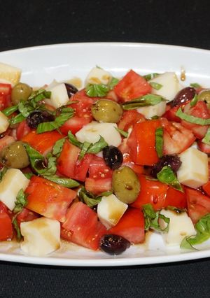 A picture of Mozzarella Cheese with Tomatoes and Balsamic Dressing.