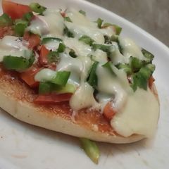 A picture of Kulcha pizza on tawa.