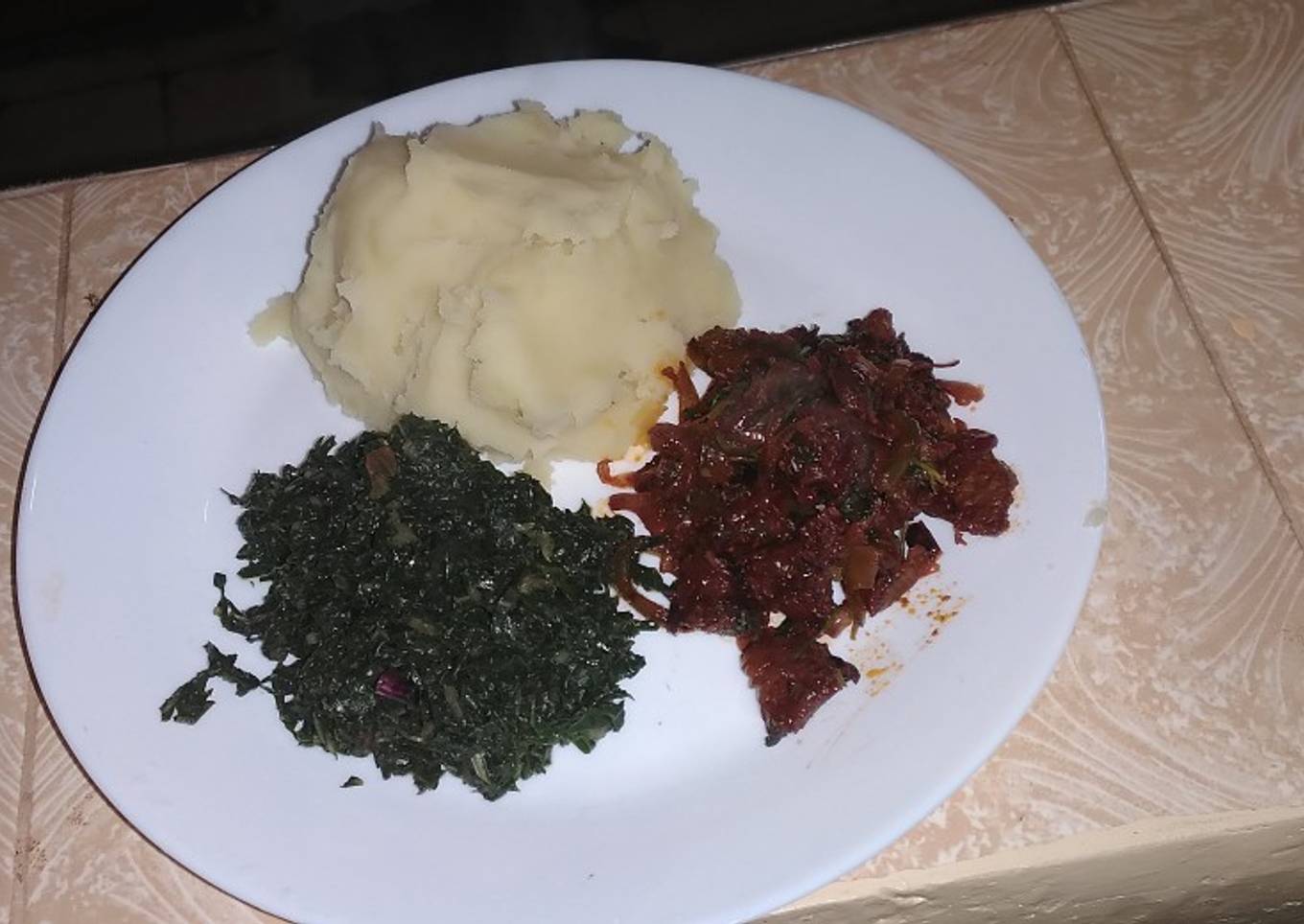 Pork with mashed potatoes served with spinach
