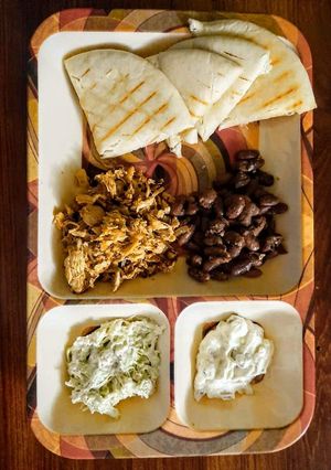 A picture of Shawarma Platter with Mayo Dip,Tartar Sauce and Sauted Kidney Bean.
