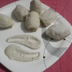 A picture of Pitha with peanut chutni.