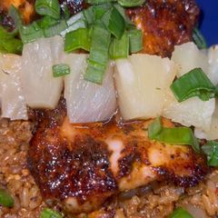A picture of Pineapple fried rice/ jerk chicken.